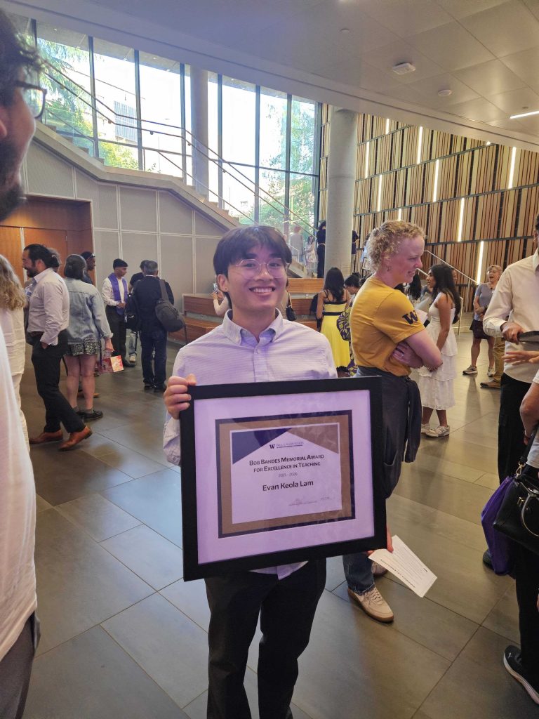 Evan Lam holding the Bob Bandes Teaching Award